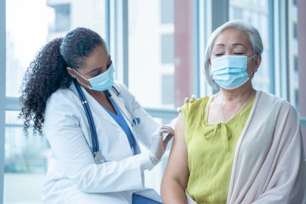 istock Doctor Preparing a Woman's Arm for Vaccination 1346566709