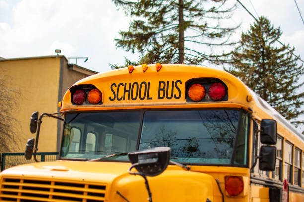 istock Yellow empty school bus waiting for kids outdoors 1346567498