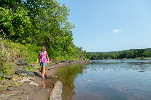 Sister and brother on the bank of the St. Croix River on a beautiful summer day.