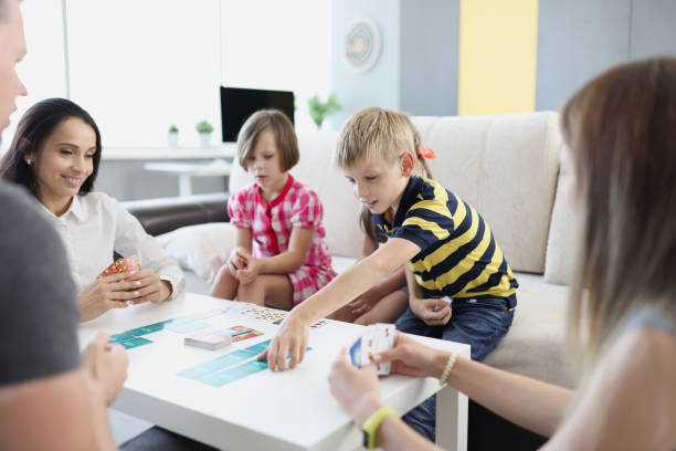 istock Children and parents playing board games at home 1346569073