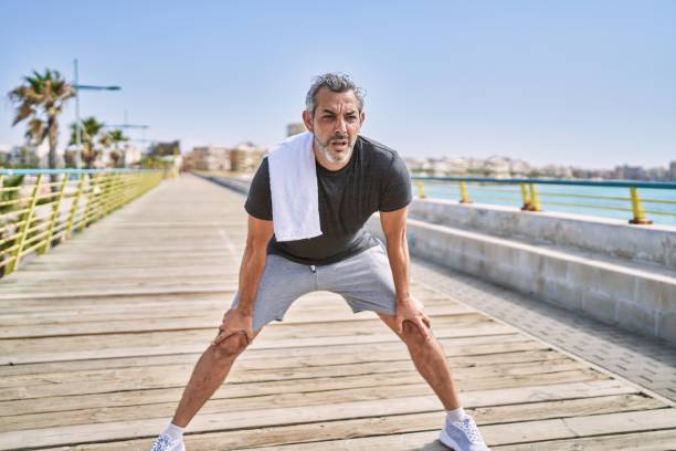 istock Middle age hispanic man wearing sportswear resting at seaside 1346569398