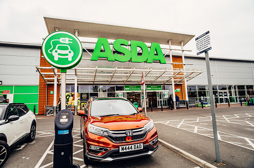 Carlisle, England - September, 04 2021: Electric car charging outside the Asda St Nicholas Gate store on London Road, Carlisle, England.