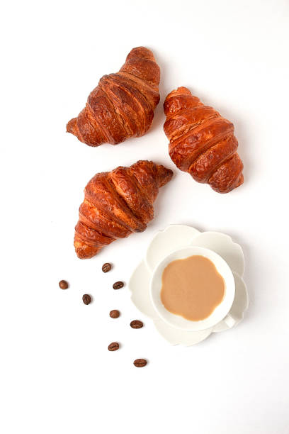 istock Croissants with a cup of coffee, on a white background, top view, no people, horizontal, 1346571850