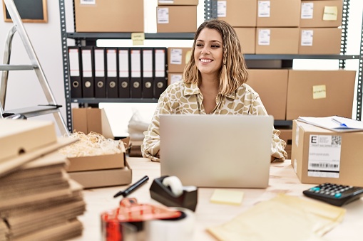 Young hispanic woman smiling confident working at office