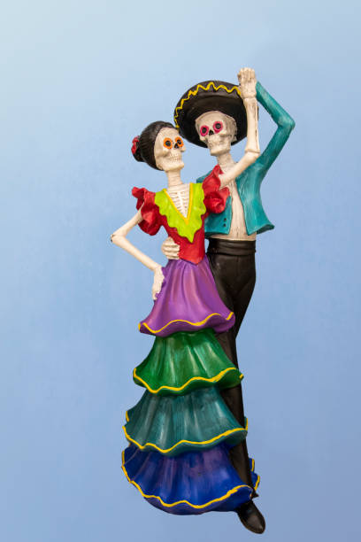 istock Dancing dia la Muertos couple - Ceramic decoration - against blue gradient background. 1346572484