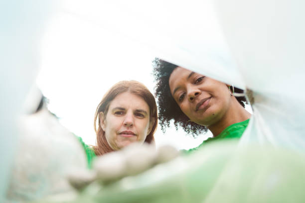 istock Volunteers collecting plastic in bag 1346572523