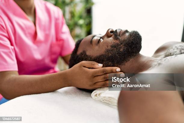 African American Man Reciving Head Massage At The Clinic Stock Photo - Download Image Now