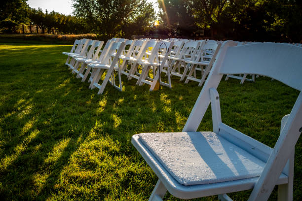 istock Outdoor wedding setting with chairs green grass and  Sunset. 1346574070