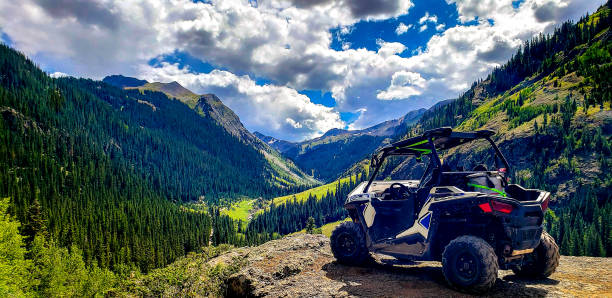 ATV and Engineer Pass, Colorado ATV with a beautiful mountain Engineer Pass. off road vehicle stock pictures, royalty-free photos & images