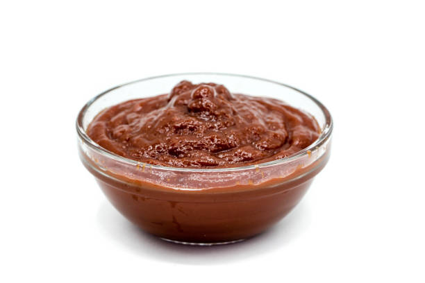 istock Ketchup in glass bowl isolated on white background 1346574807