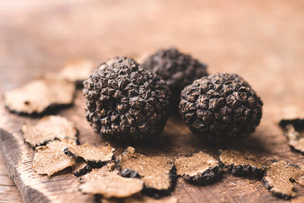 istock Black truffles on the old wooden table, rustic style, selective focus 1346575535