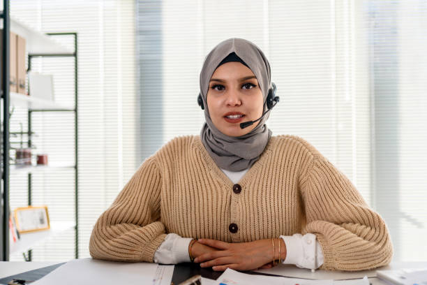 istock Black Islamic Lady In Hijab And Headset Having Video Call On Laptop 1346576270