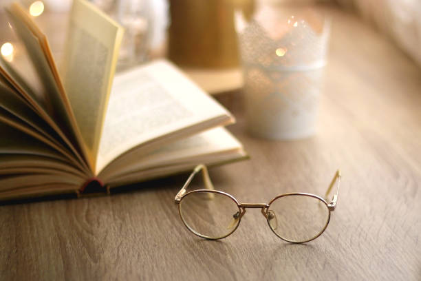 istock Book, Reading Glasses and Candles 1346576370