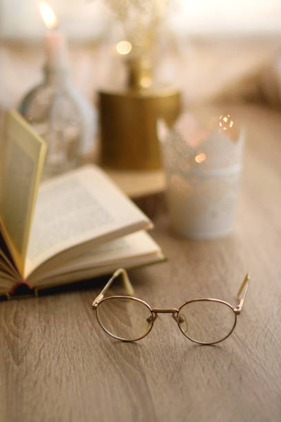 istock Book, Reading Glasses and Candles 1346576416