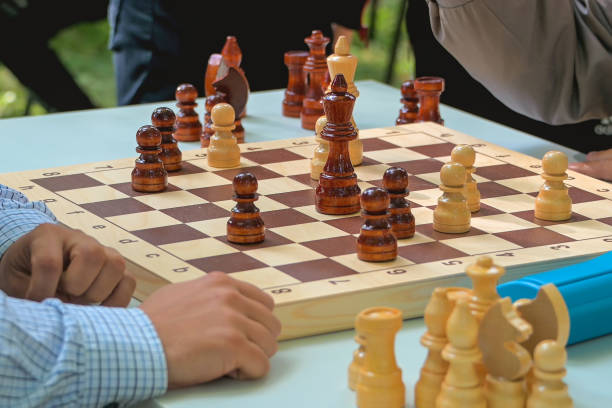 istock two adult men play chess on a table in nature 1346578326