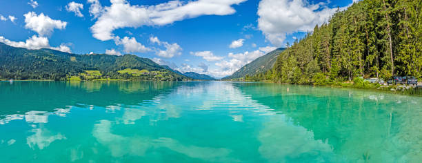 istock Panoramic view over turquoise lake Weissensee in Austrian province Carinthia during daytime 1346580541