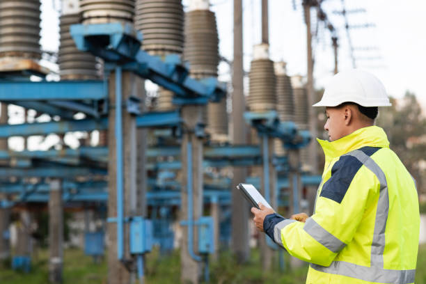 istock Energy business technology industry concept. Electrical engineer studying reading on tablet. Electrical worker engineer working with digital tablet near tower with electricity 1346581686