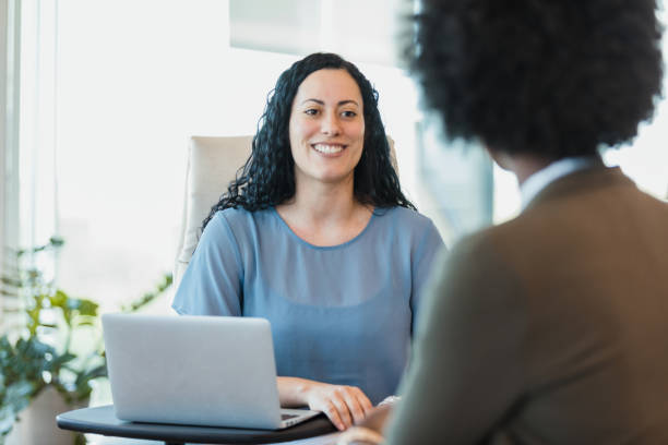 istock Female CEO smiles while interviewing female candidate for job 1346582419