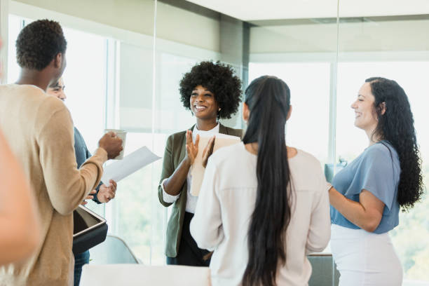 istock Diverse group of colleagues laugh and talk together 1346582449