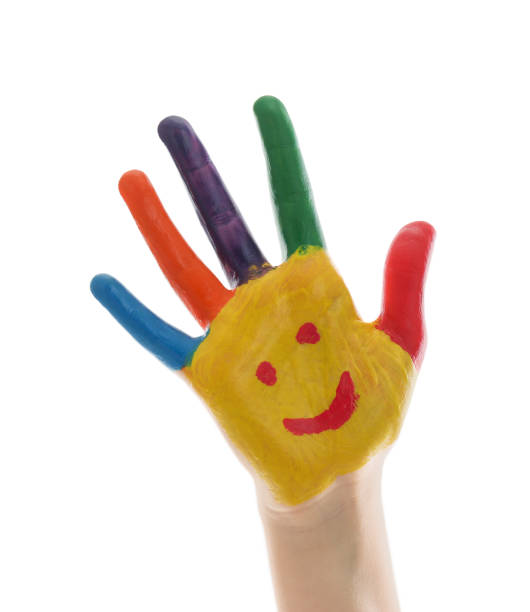 istock Kid with smiling face drawn on palm against white background, closeup 1346584900