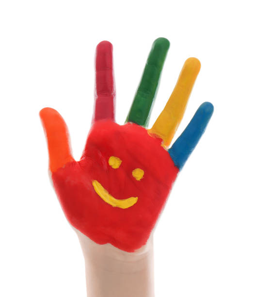 istock Kid with smiling face drawn on palm against white background, closeup 1346584910