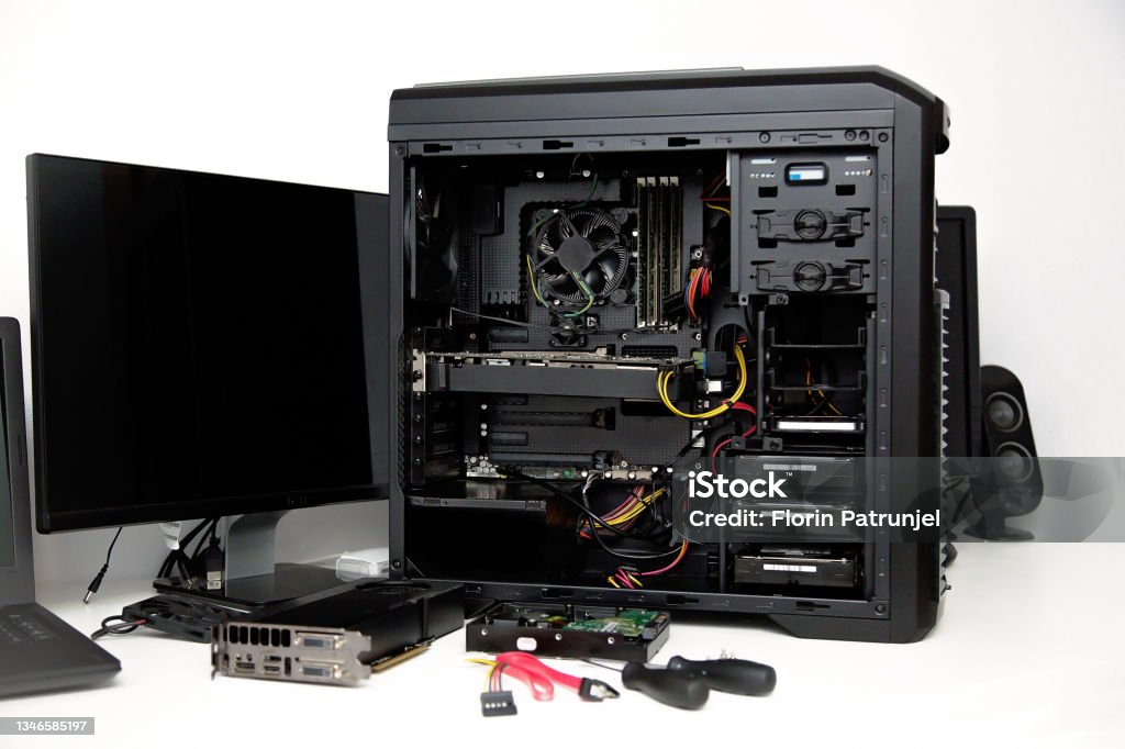 Building of PC, ATX motherboard and computer power supply unit inserted to black midi tower case CPU Stock Photo