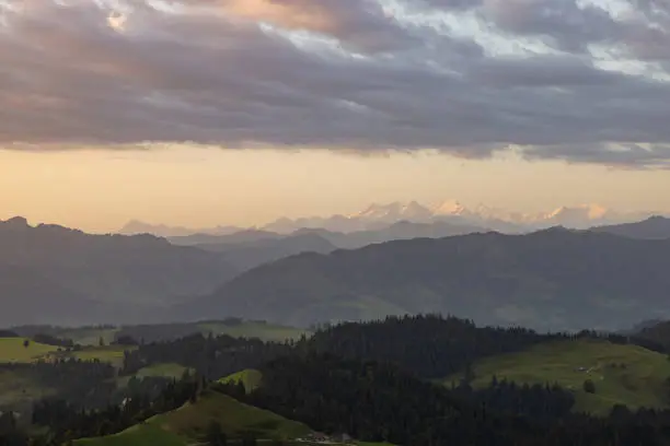 Photo of Amazing sunset at a wonderful landscape in Switzerland on a hill called Napf. Wonderful morning view with the alps in the horizon.