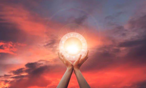 Zodiac signs inside of horoscope circle in woman hand at sunset. Astrology and horoscopes. Zodiac signs inside of horoscope circle in woman hand at sunset. Astrology and horoscopes chinese zodiac sign photos stock pictures, royalty-free photos & images