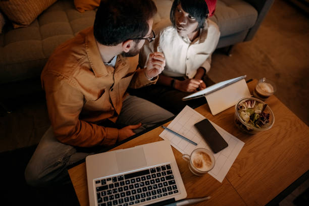 istock Happy couple using laptop on the floor 1346587488