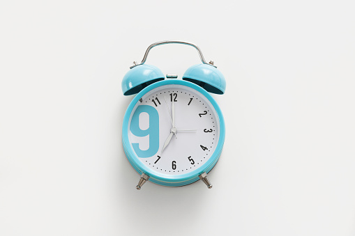 Blue alarm clock on the white background. Morning, time to wake up