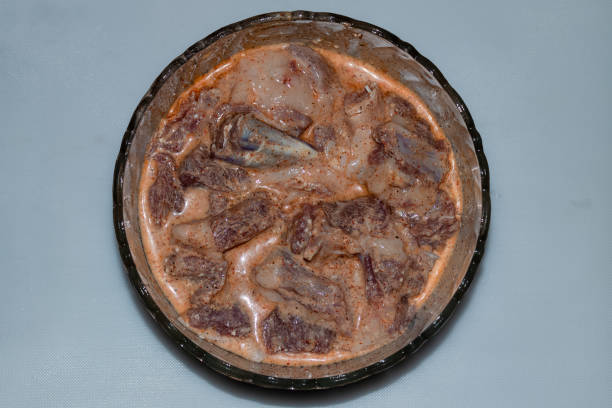 istock Raw meat products, Marinated Lamb Meat or mutton in bowl isolated on white background top view 1346588006