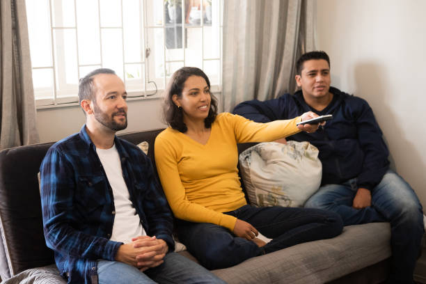 istock friends watching television together on the couch 1346592748
