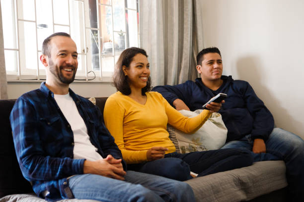 istock friends watching television together on the couch 1346592754