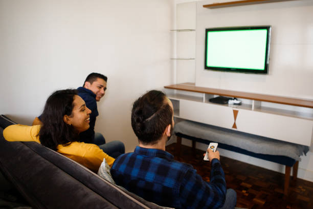 istock friends watching television together on the couch 1346592826