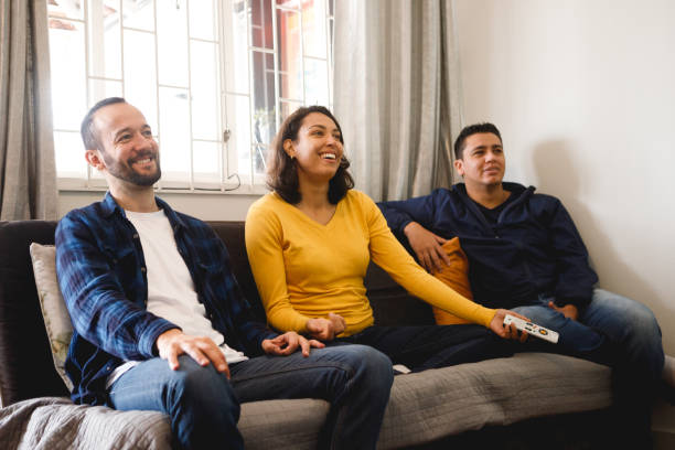 istock friends watching television together on the couch 1346592851