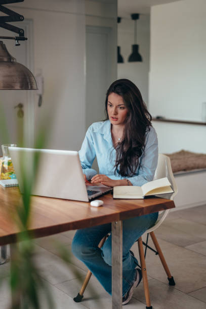 istock Businesswoman using a laptop while working from home 1346594454