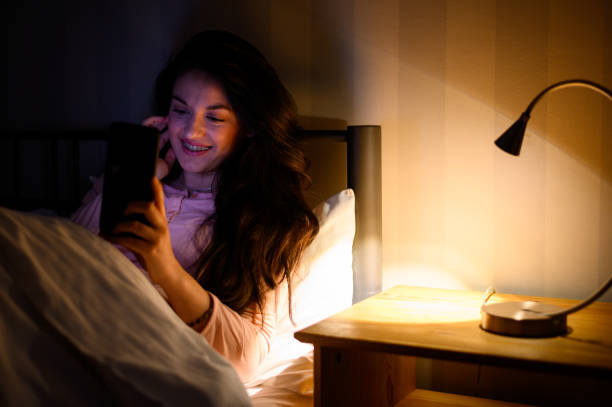 istock Woman lying in her bed during night and using a smartphone 1346594463