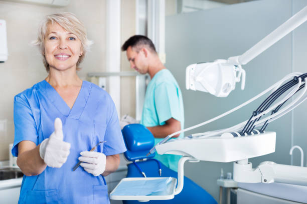 istock Female dentist smiling with thumb up 1346594737