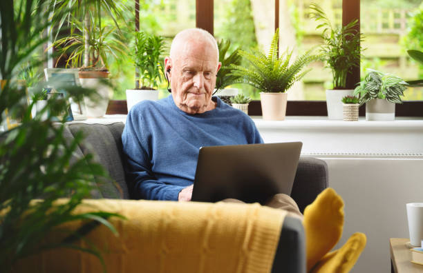 istock Shot of a senior man using his laptop while sitting at home 1346595637
