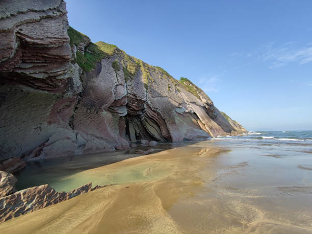 istock beach with flysch rock formations and cliff at Zumaia, Pais Vasco Spain 1346596348