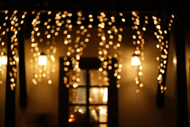 istock Cozy house with garlands, window with light, background for Christmas mood 1346597073