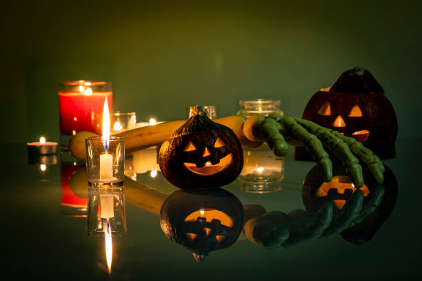 istock Halloween pumpkins, candles and skeleton arm 1346599364