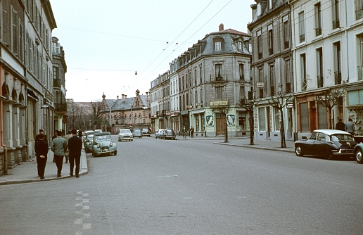 Paris, Il de France, France, 1962. Street scene in a Paris suburb. Furthermore: pedestrians, cars, houses and shops.