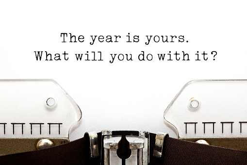 Inspirational quote The year is yours. What will you do with it? typed on old typewriter.