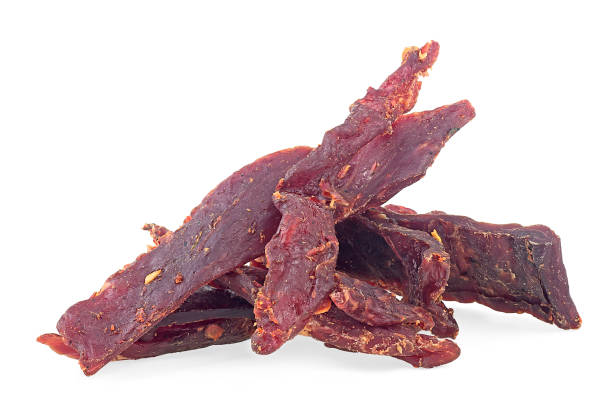 istock Portion of spiced beef jerky isolated on a white white background. Dried peppered beef jerky. 1346604470