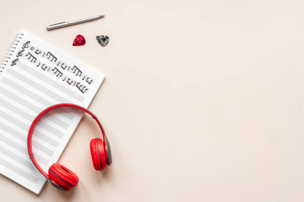 istock Music sheets with musical notes and headphones, top view 1346604710