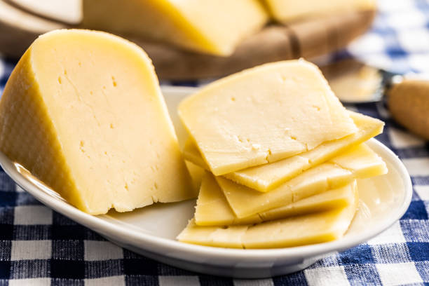 istock Block of hard cheese. Sliced cheese. 1346608950