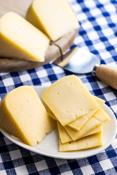 istock Block of hard cheese. Sliced cheese. 1346608958
