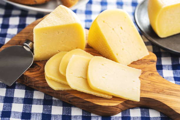 istock Block of hard cheese. Sliced cheese. 1346608975