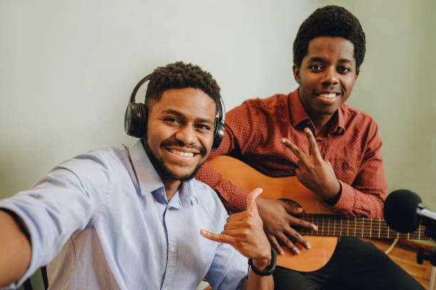 istock Two young African-Americans playing musical instruments at home 1346609950